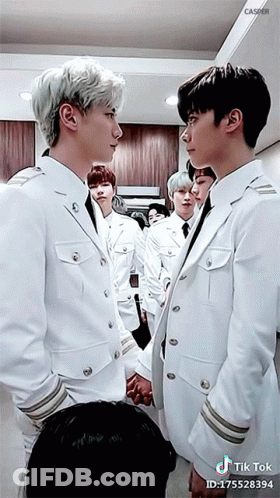 Young Men In White Suits Holding Hands GIF