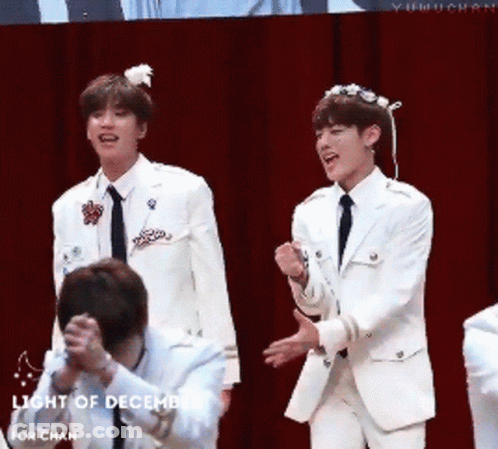 Young Men In White Suits On Stage Light Of December GIF
