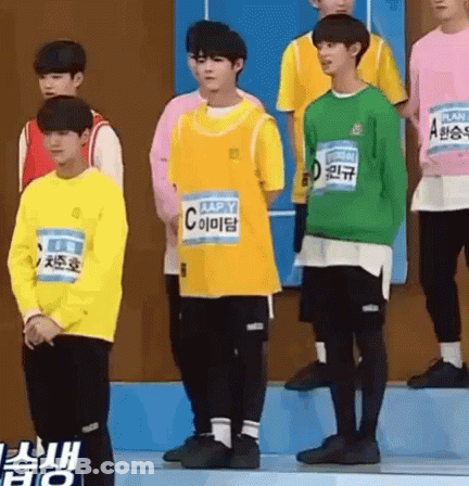 Young Men In Yellow Shirts And Green Sweatshirts On Stage GIF
