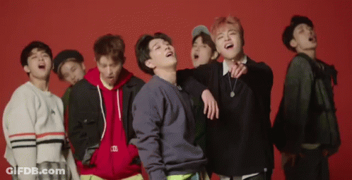 Young Men Laughing On Red Background GIF