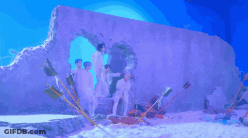 Young Men Posing In Front Of Hole In Wall GIF
