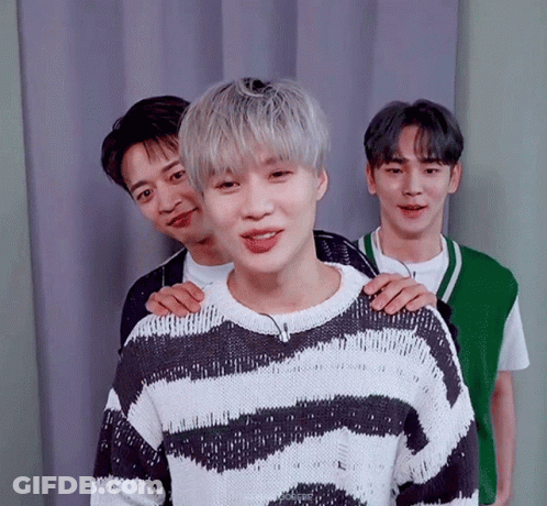 Young Men Posing One In Striped Sweater GIF