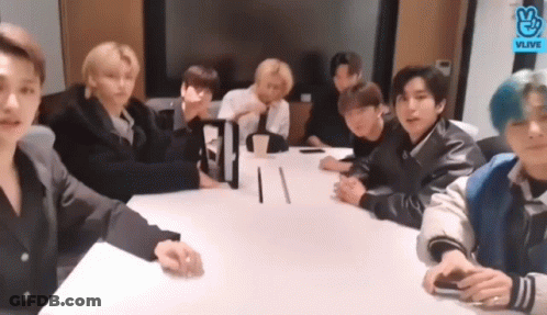Young Men Sitting Around Conference Table GIF