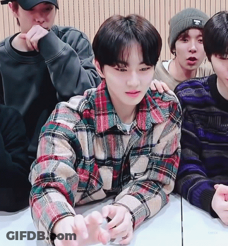 Young Men Sitting Around Table One In Plaid Shirt GIF
