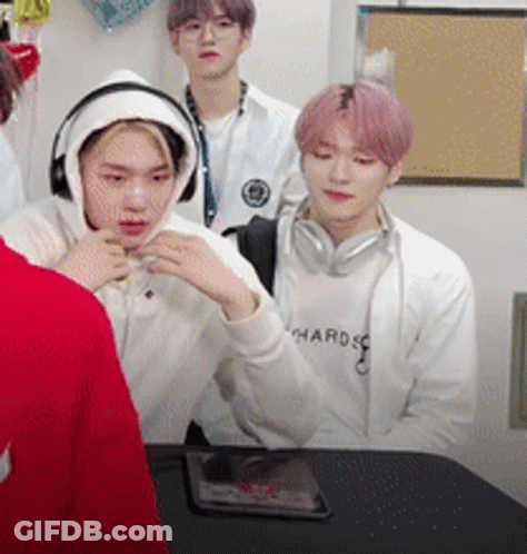 Young Men Sitting Around Table Wearing Headphones GIF