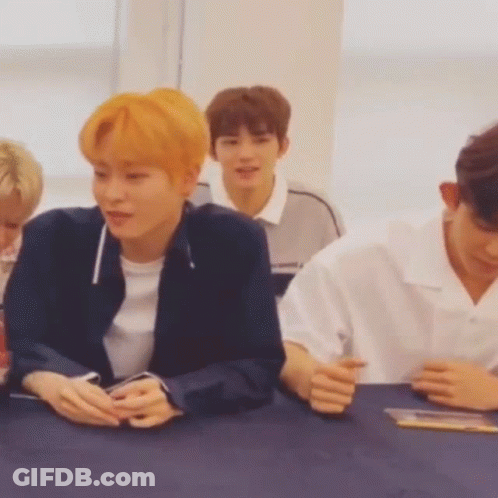 Young Men Sitting At Table With Hands Folded GIF