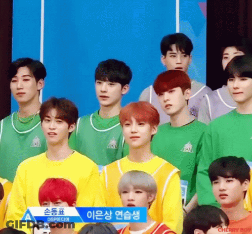 Young Men Sitting In Front Of Sign Saying A GIF