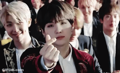 Young Men Sitting In Row Making Heart With Hand GIF