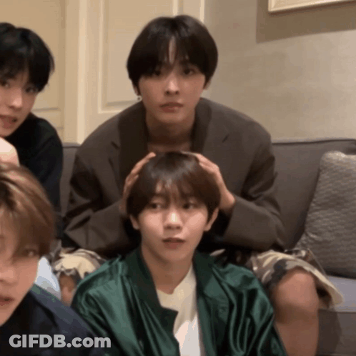 Young Men Sitting On Couch One Holding Head GIF