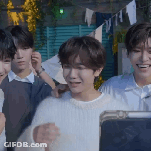 Young Men Smiling At Tablet GIF