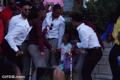 Young Men Standing Around Little Girl With Cane GIF