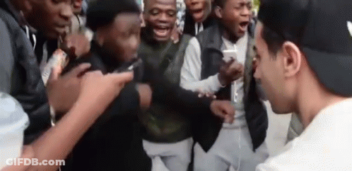 Young Men Standing Around Man In Hat GIF