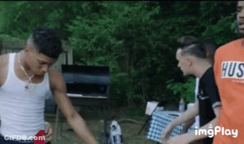 Young Men Standing By Barbecue Grill GIF