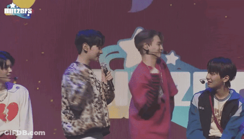 Young Men Standing In Front Of Blitzers Sign GIF