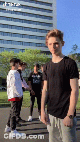 Young Men Standing In Front Of Building With TikTok GIF