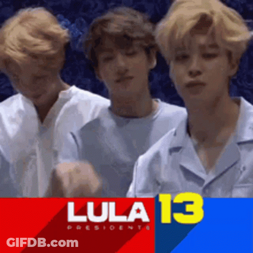 Young Men Standing In Front Of Lula 13 Banner GIF