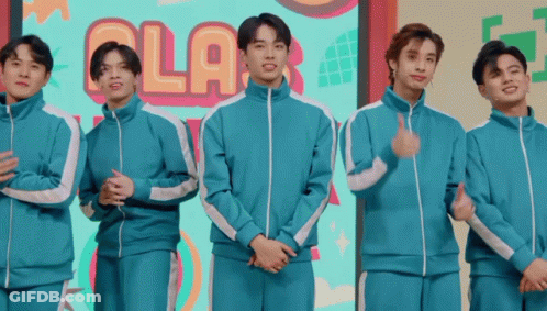 Young Men Standing In Front Of Ola Sign GIF