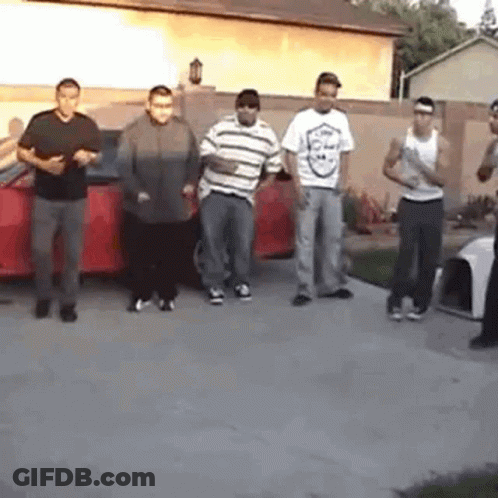 Young Men Standing In Front Of Red Car GIF