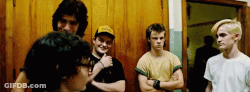 Young Men Standing In Front Of Wooden Door GIF