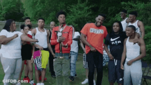 Young Men Standing In Grassy Field GIF