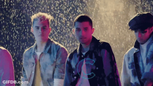 Young Men Standing In Rain With C Shirts GIF