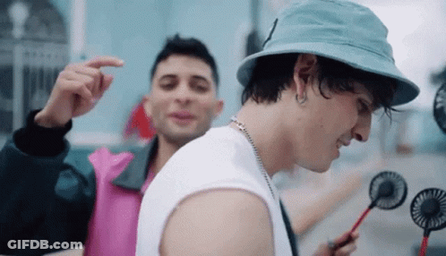 Young Men Standing In Rain With C Shirts GIF