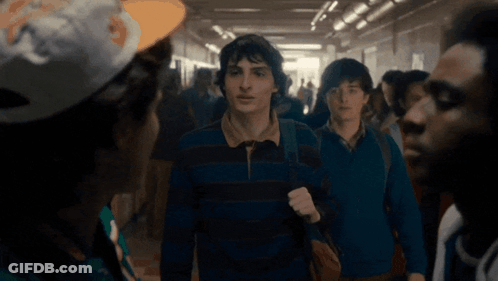 Young Men Walking Hallway NFL Hat GIF