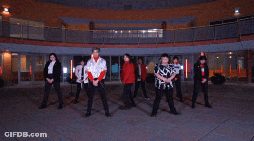 Young People Dancing In Front Of Large Building GIF