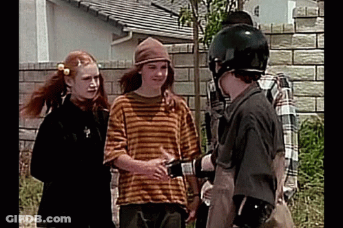 Young People Talking In Front Of Brick Wall GIF
