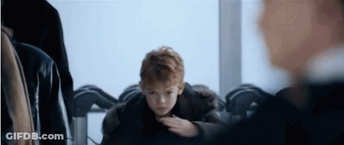 Young Red-Haired Boy Sitting At Table GIF