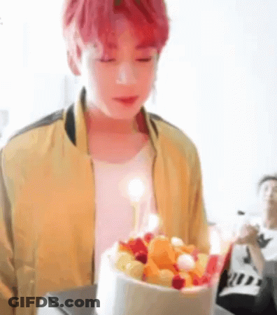 Young Red-Haired Man Holding Cake With Candle GIF