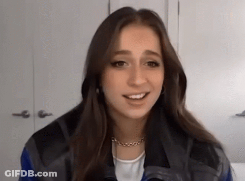 Young Woman In Blue And Black Jacket Smiling GIF