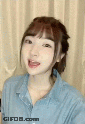 Young Woman In Blue Shirt Making Funny Face GIF