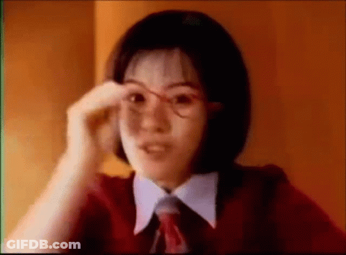 Young Woman In Glasses And Red Tie Adjusting Glasses GIF