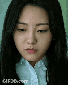 Young Woman In Green Sweater Making Heart With Hands GIF