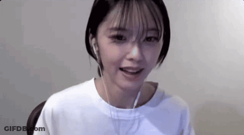 Young Woman In Headphones Sitting At Computer GIF