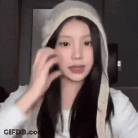 Young Woman In White Hoodie Touching Hair GIF