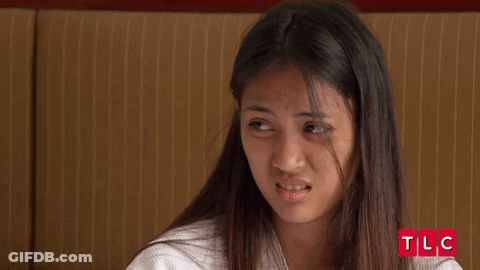 Young Woman Making Funny Face At TLC Logo GIF