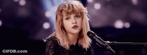 Young Woman Singing Into Microphone GIF