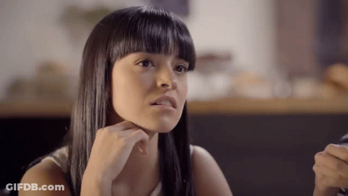 Young Woman Sitting At Table GIF