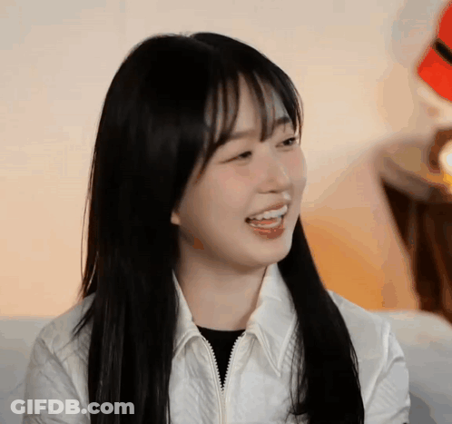 Young Woman With Black Hair And Bangs Smiling GIF