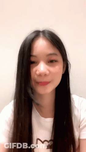 Young Woman With Long Black Hair In Cat Shirt GIF
