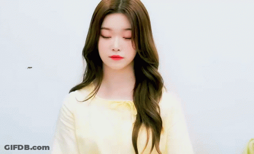 Young Woman With Long Brown Hair In Yellow Shirt GIF