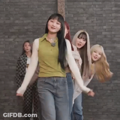 Young Women Dancing In Front Of Brick Wall GIF