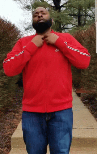 Man Flexing His T-shirt With 100 Logo GIF