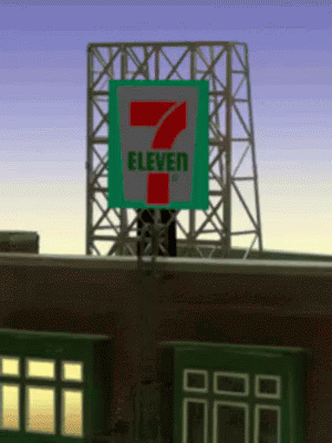 A 7 Eleven Sign On Top Of A Brick Building GIF