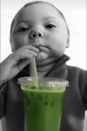 Baby Drinks Green Smoothie Through Straw GIF