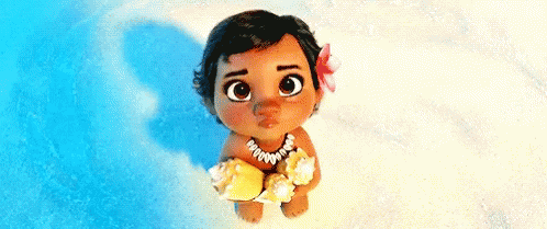 A Baby From The Movie Moana Is Sitting On The Beach Holding A Sea Shell . GIF