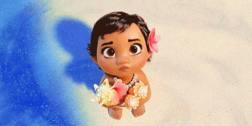 A Baby From The Movie Moana Is Standing On The Beach Holding A Seashell And A Flower . GIF