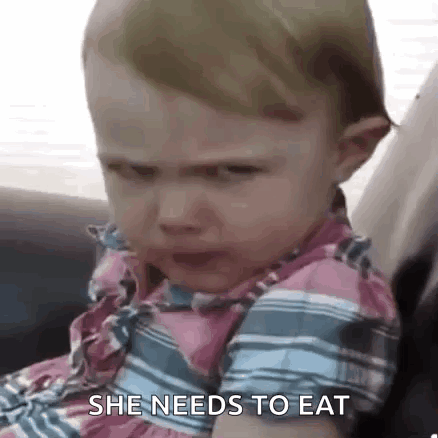 A Baby Girl Is Crying While Sitting In A Car Seat And Says `` She Needs To Eat '' . GIF